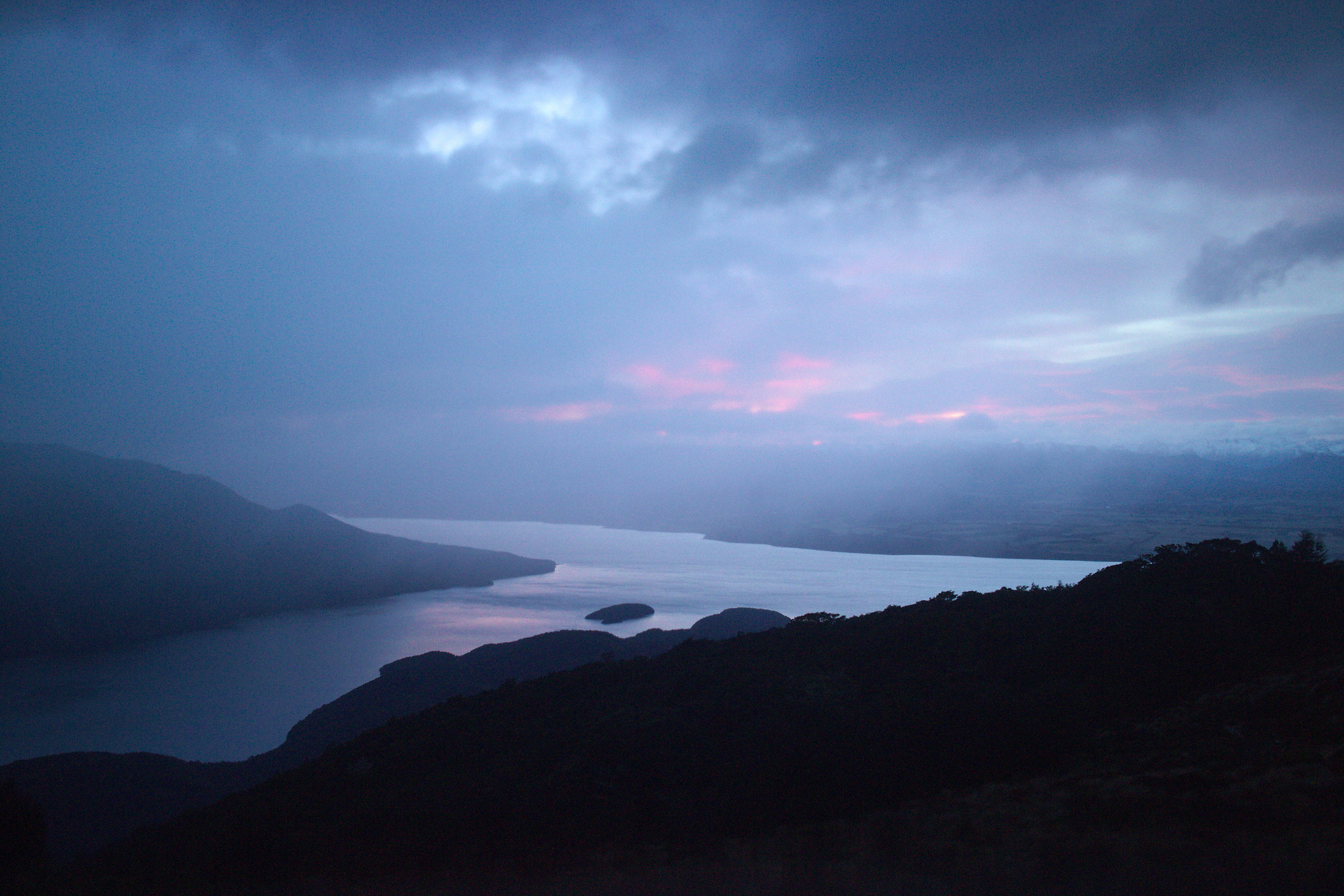 Early morning view over Lake Te Anau in Luxmore Hut on the Kepler track in Fiordland National Park
